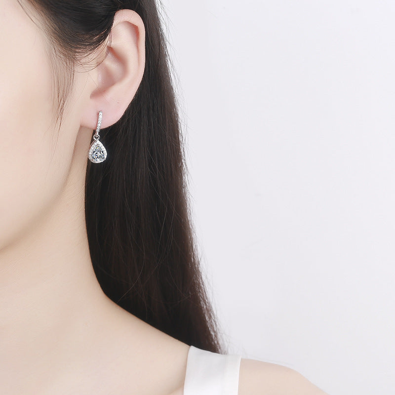 Halo zircon teardrop earring worn on the ear