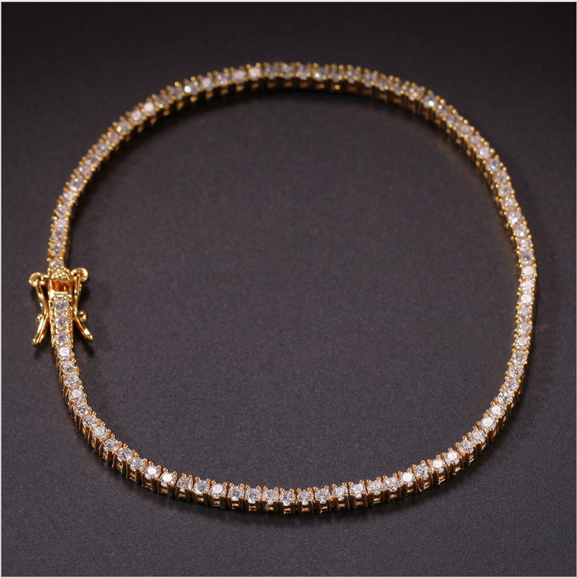 Gold-tone tennis bracelet laid flat with box clasp