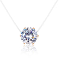 Round zircon pendant on a clear cord with rose gold-tone prongs, white background