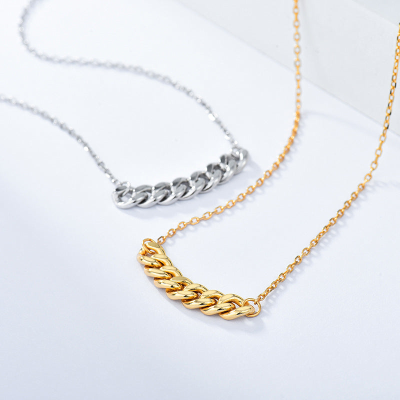 Silver-tone and gold-tone curb chain bar necklaces side by side on a white surface