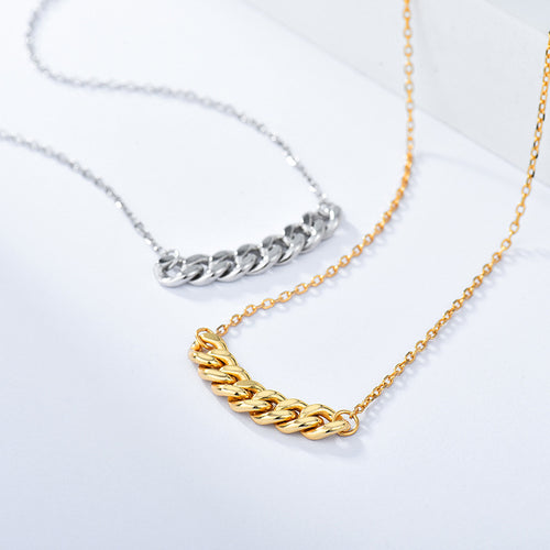Silver-tone and gold-tone curb chain bar necklaces side by side on a white surface