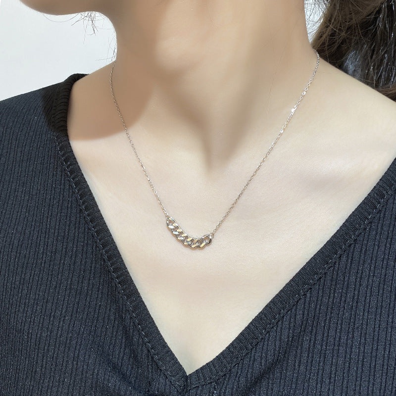 Silver-tone curb chain bar necklace worn at the neckline