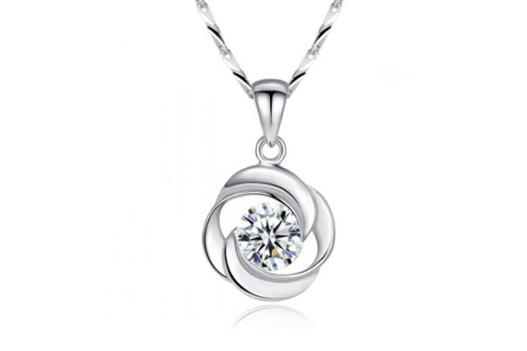 Silver-tone swirl pendant with clear zircon stone on a twisted chain, white background