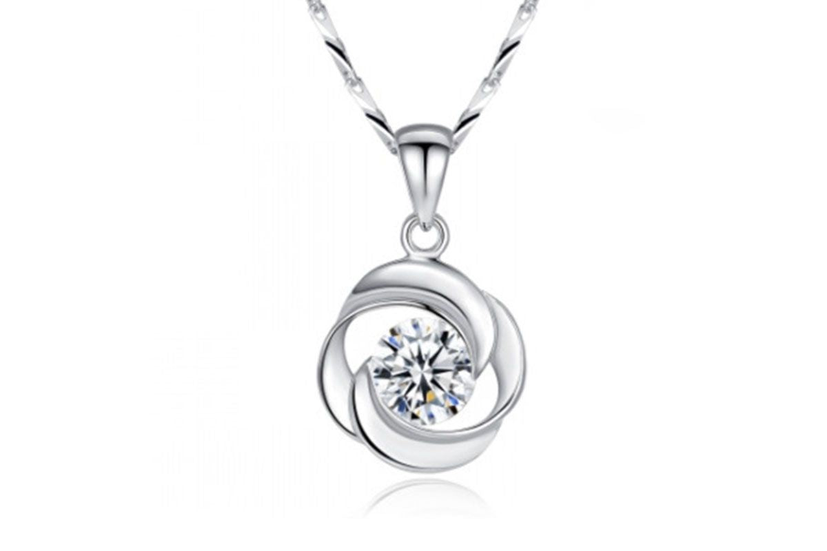 Silver-tone swirl pendant with clear zircon stone on a twisted chain, white background