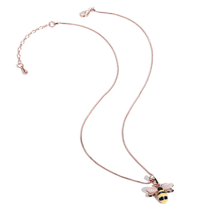 Rose gold-tone bee pendant necklace laid flat with extension chain visible