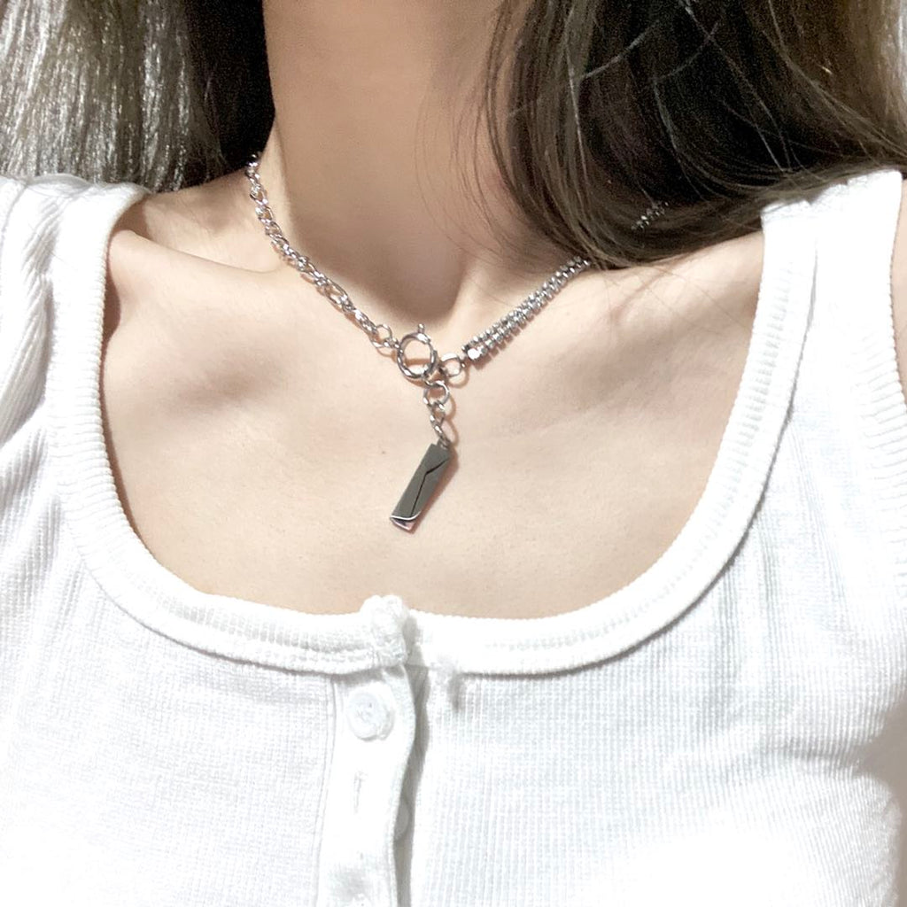 Silver-tone toggle chain necklace with a bar pendant on the collarbone