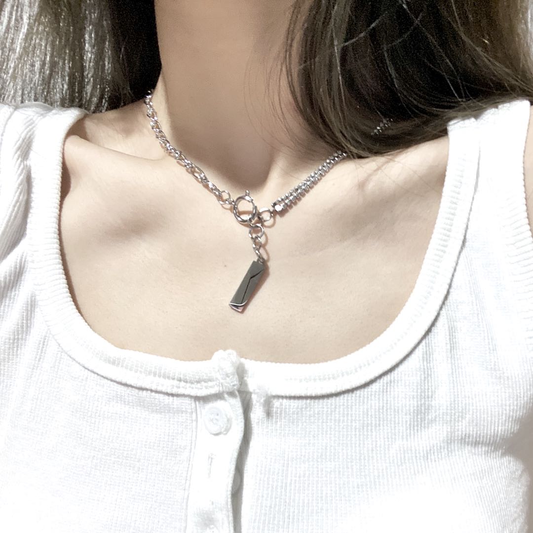 Silver-tone toggle chain necklace with a bar pendant on the collarbone