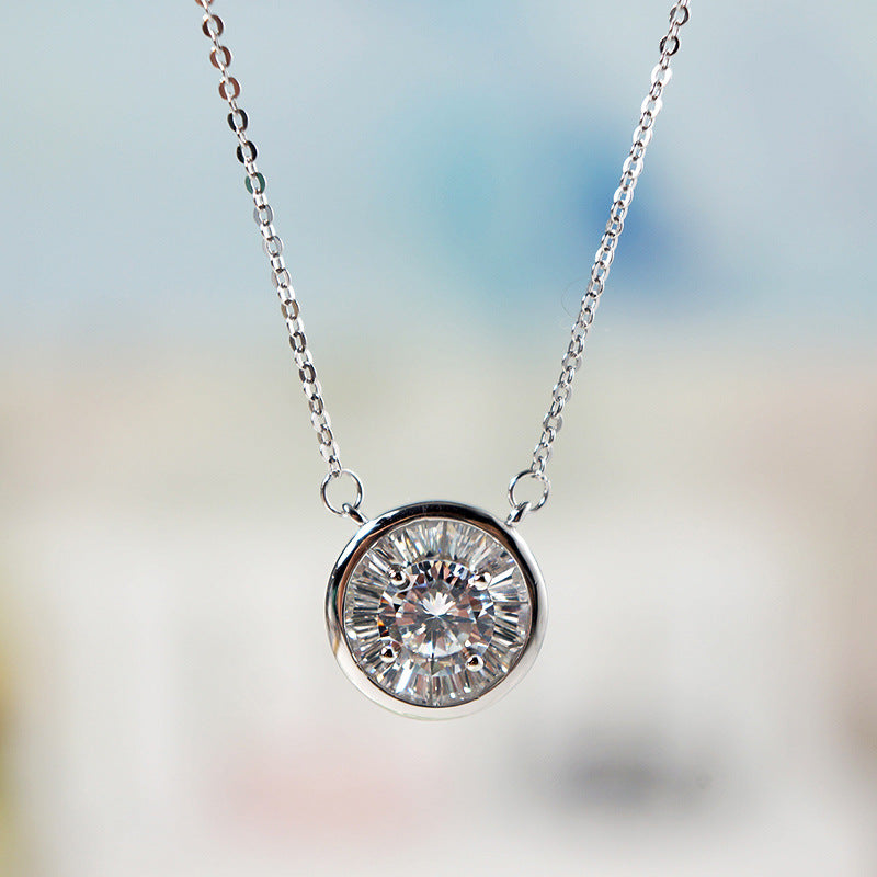 Close-up of a round zircon pendant on a silver-tone chain against a soft blue background
