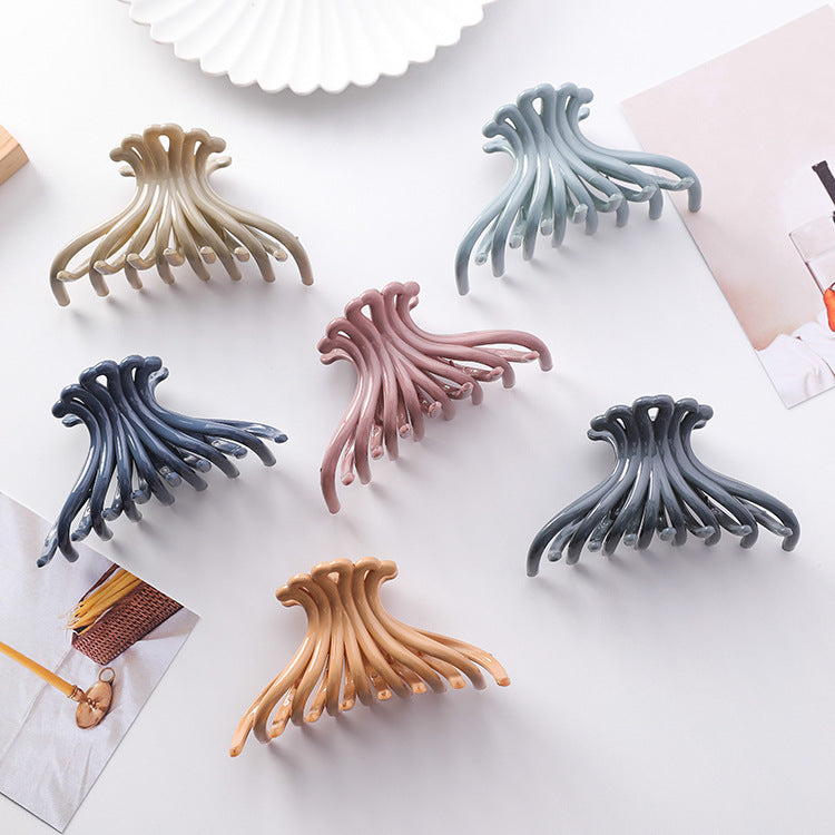 Six wave hair claw clips in navy, slate, pale blue, pink, khaki and apricot shades