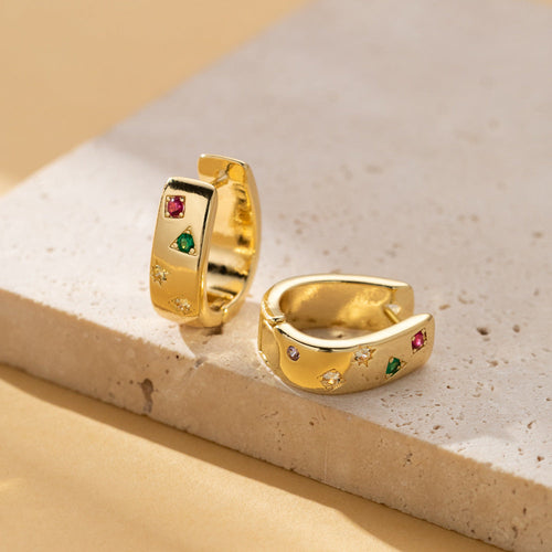 Gold-tone huggie hoops set with tiny pink, green and clear zircon accents in star-shaped settings