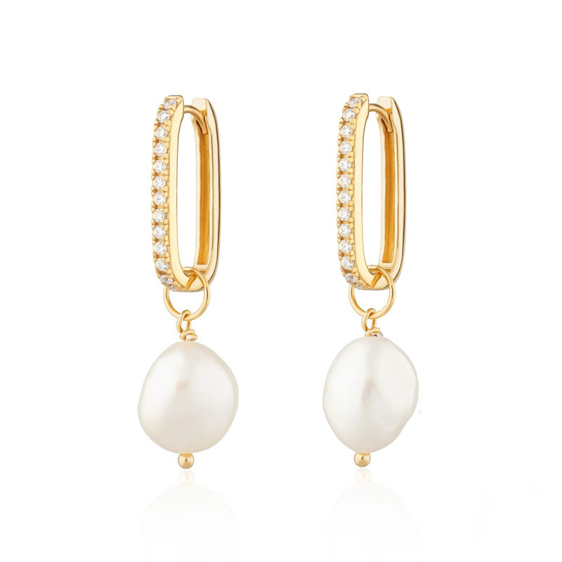 Gold-tone oval hoop earrings with a row of zircon stones and an irregular pearl-style drop