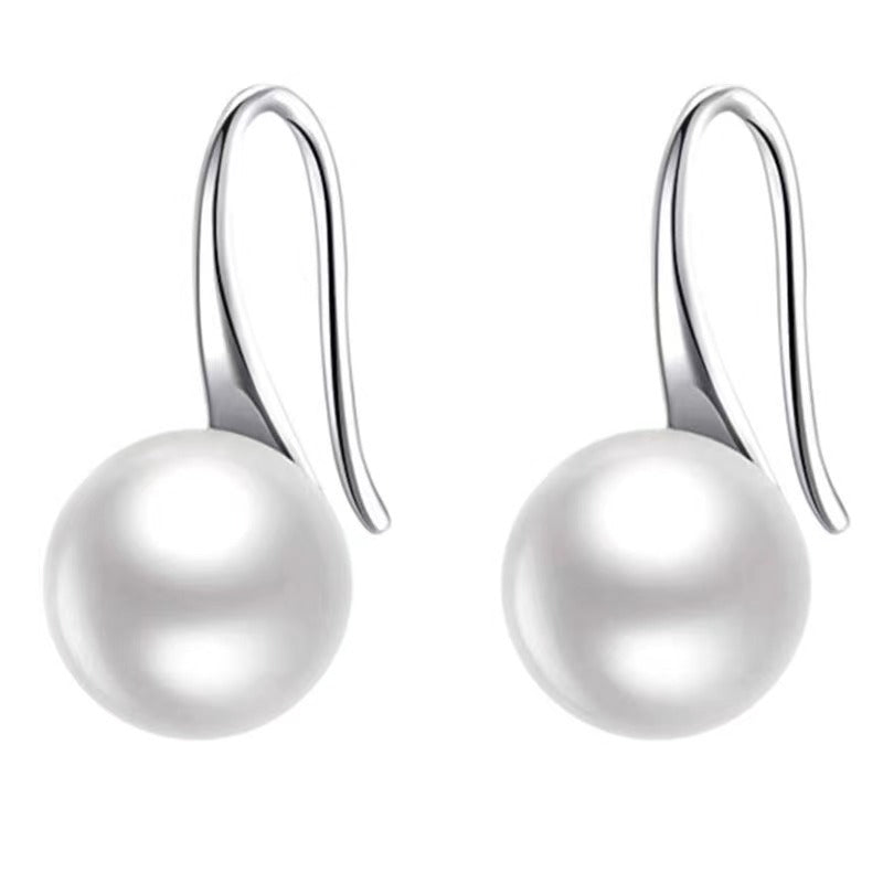 Silver-tone hook drop earrings with a round pearl-style bead on a white background