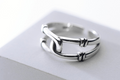 Silver-tone double band open ring on a grey block