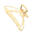 Gold-tone open-frame claw clip with a curved, swooping outline, on a white background