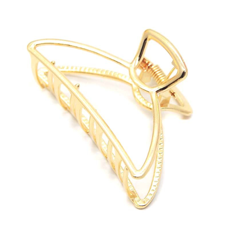 Gold-tone open-frame claw clip with a curved, swooping outline, on a white background