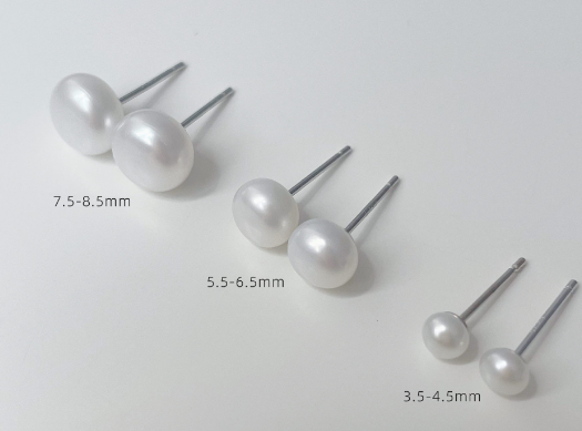 White pearl-style stud earrings in three sizes with silver-tone posts, size chart