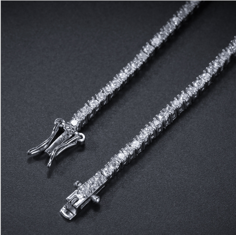 Close-up of a silver-tone tennis bracelet box clasp and zirconia stones