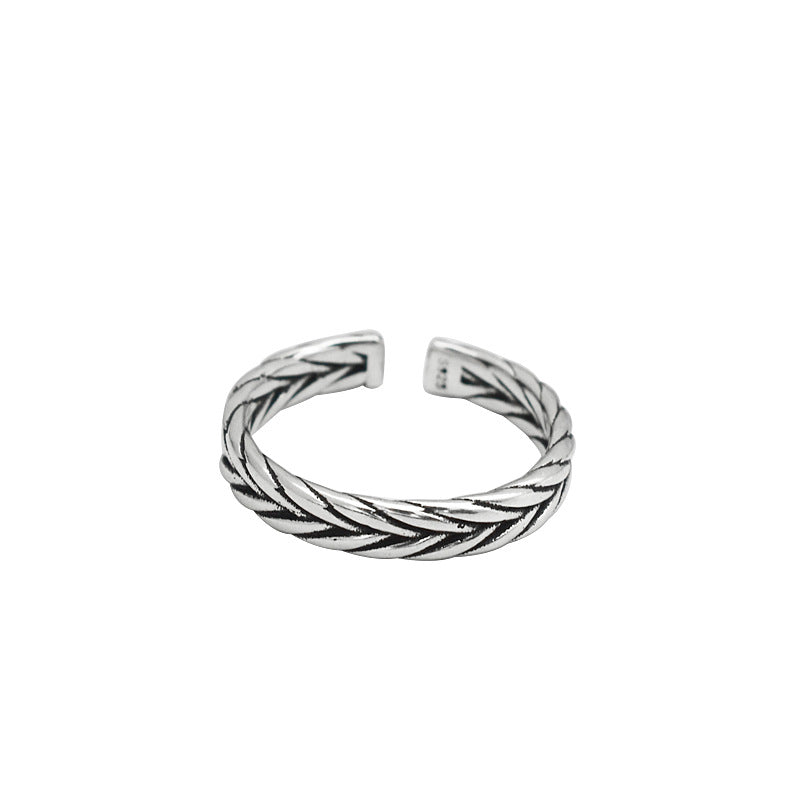 Silver-tone open band ring with a woven braided pattern and darkened recesses