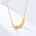 Gold-tone curb chain bar necklace close-up on a light surface