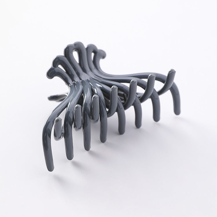 Slate grey wave hair claw clip, angled view, plain background