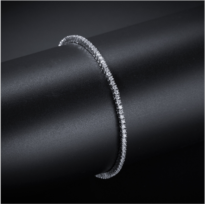 Silver-tone tennis bracelet set with zirconia stones on a dark tube